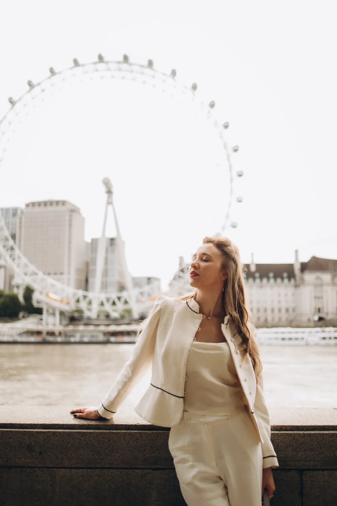 Woman on the South Bank with the London Eye behind her
